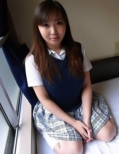Haruka Ohsawa posing in her schoolgirl uniform and hiking up her top to show her big boobs