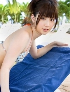 Anna Nakagawa in bath suit is playful next to the pool