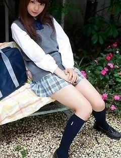 Manami Sato in short uniform skirt spends time in the park
