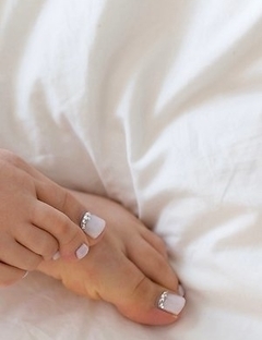 Aya Kisaki shows her toes while stroking this dude's throbbing boner