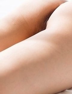 Chie Kobayashi laying on a beautiful bed while brazenly showing her legs/feet