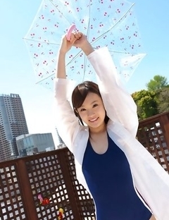 Kana Yuuki in bathsuit plays with umbrella in the balcony