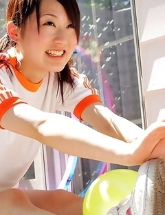 Naoko Sawano in sports outfit plays with balls in garden