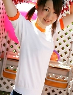 Naoko Sawano in sports outfit plays with balls in garden